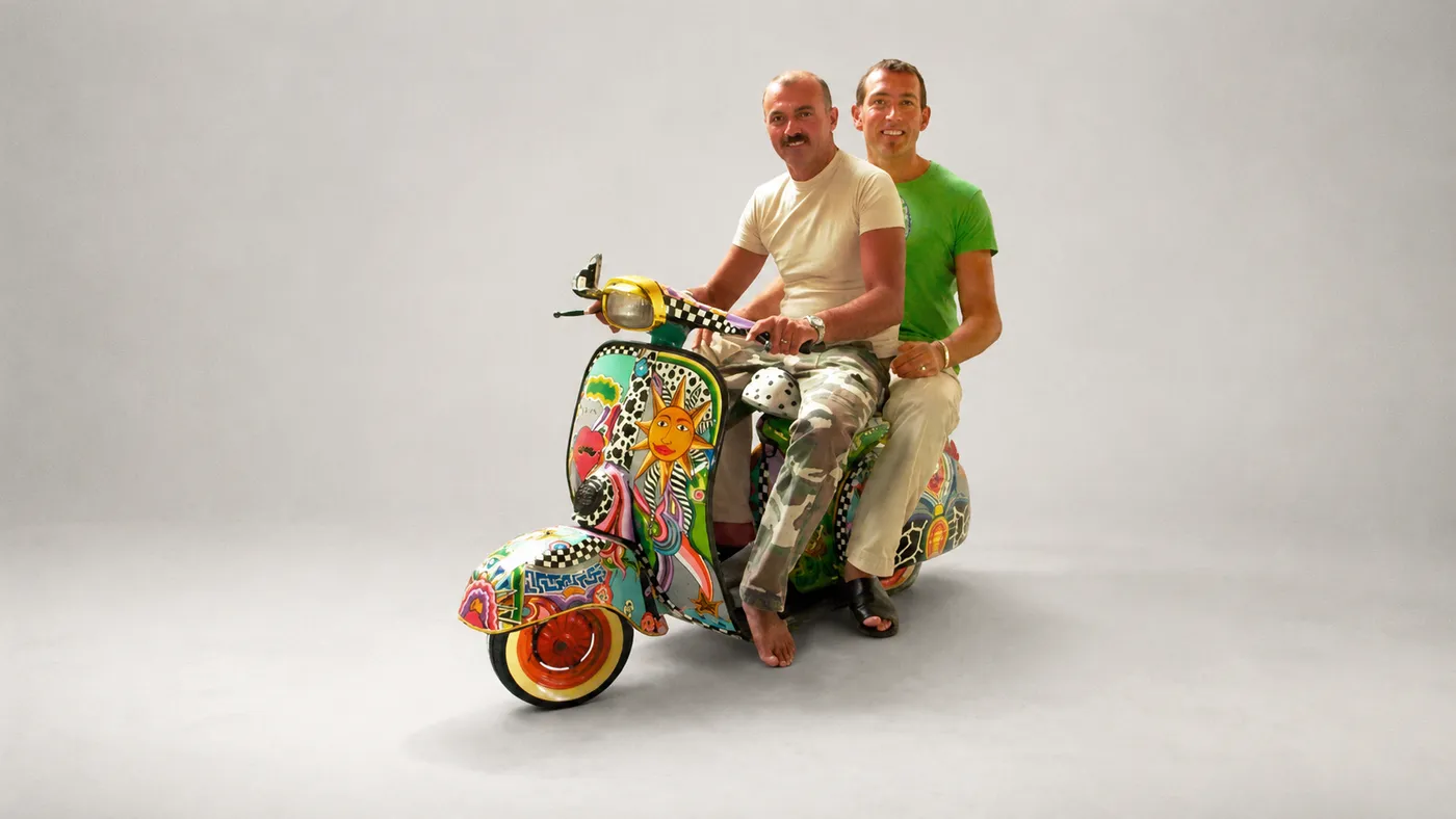 Tom Hoffmann with Arno Müller on a hand-painted Tom's Vespa