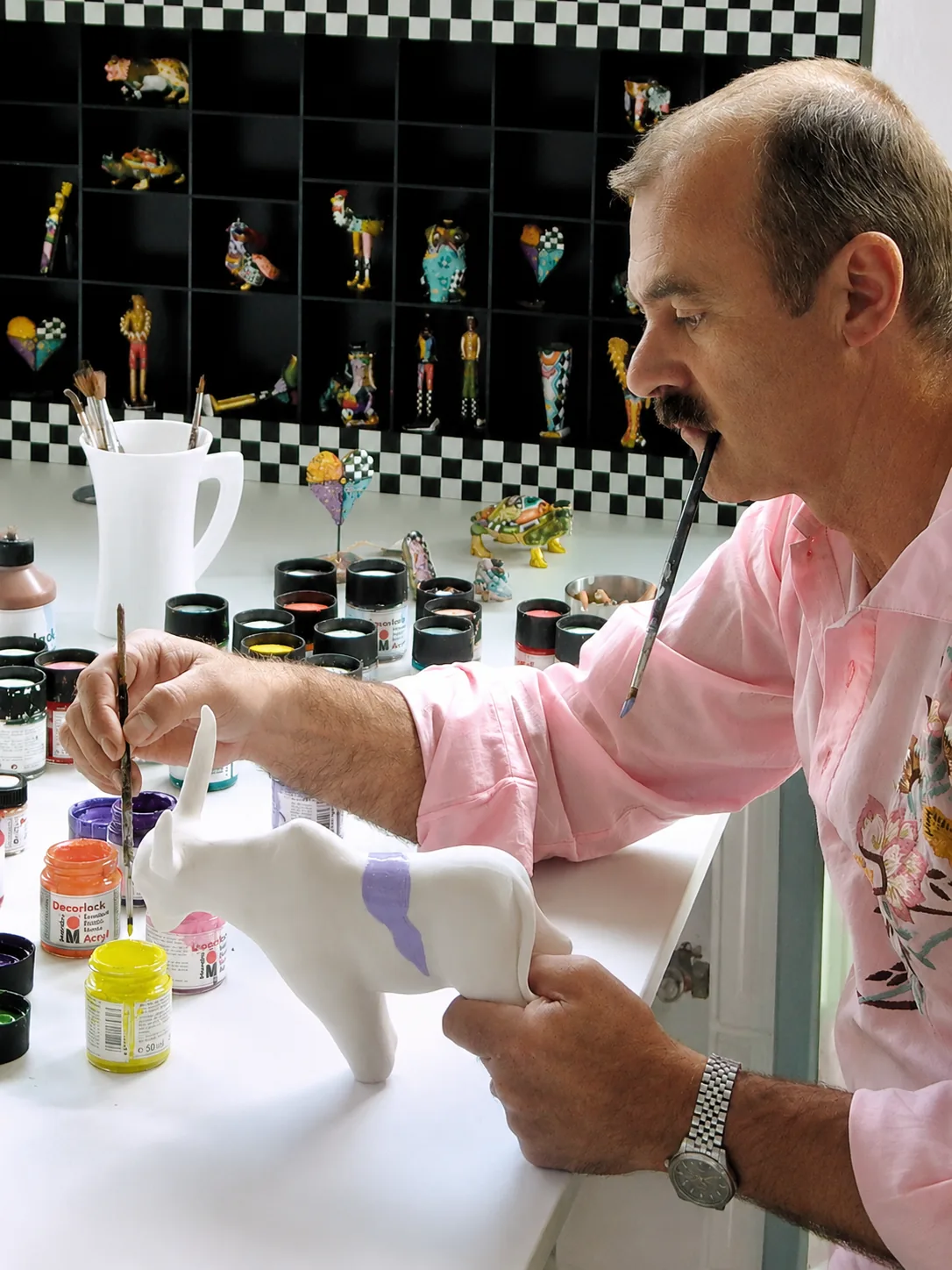 Tom Hoffmann hand-painting a Tom's piece in the atelier