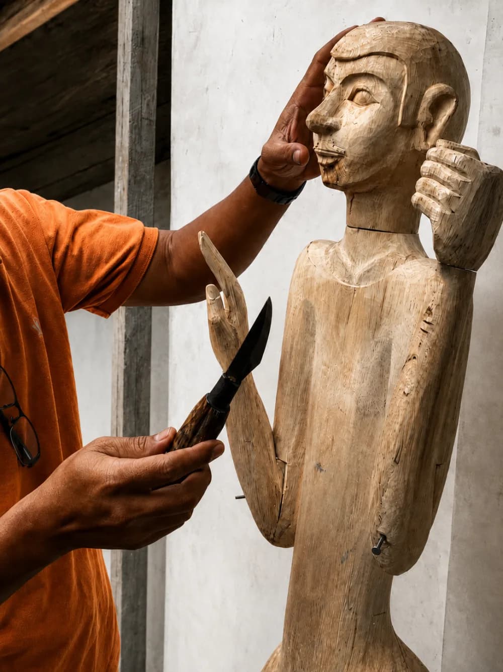 A wooden prototype being carved by hand
