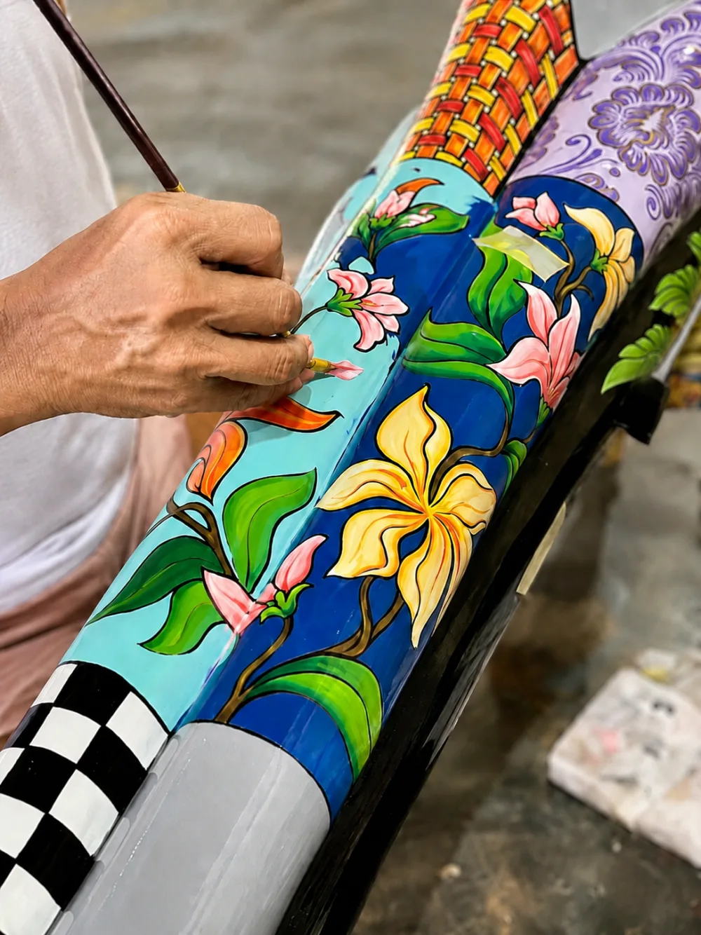 An artisan painting a character by hand